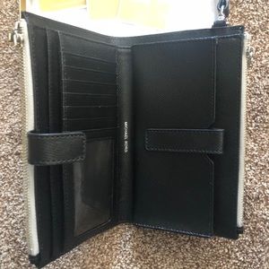 Michael Kors metallic silver wristlet.